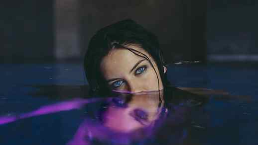 Charming Brunette with Blue Eyes in Water / Reflection