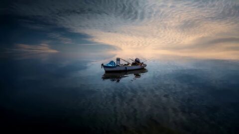 Calm Sea Water Ripples Fishing Boat 4K – Desktop Theme