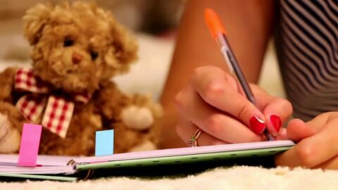 Girl Writing in Notepad | Teddy Bear